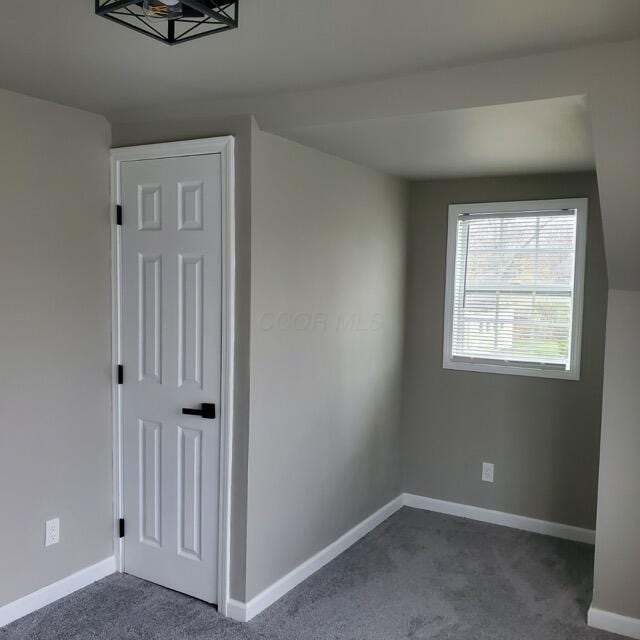 additional living space with dark carpet