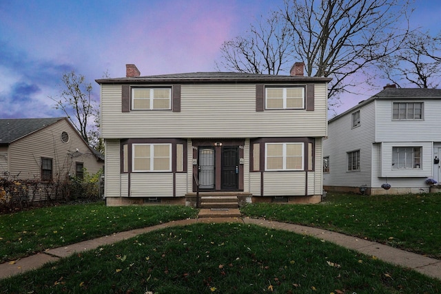 colonial-style house with a yard