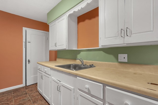 kitchen with white cabinetry and sink