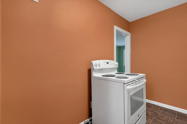 kitchen featuring white electric range, a textured ceiling, and light tile patterned floors