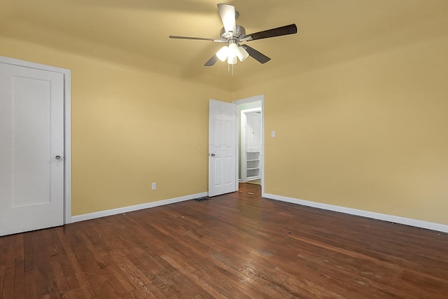 spare room featuring ceiling fan and dark wood-type flooring