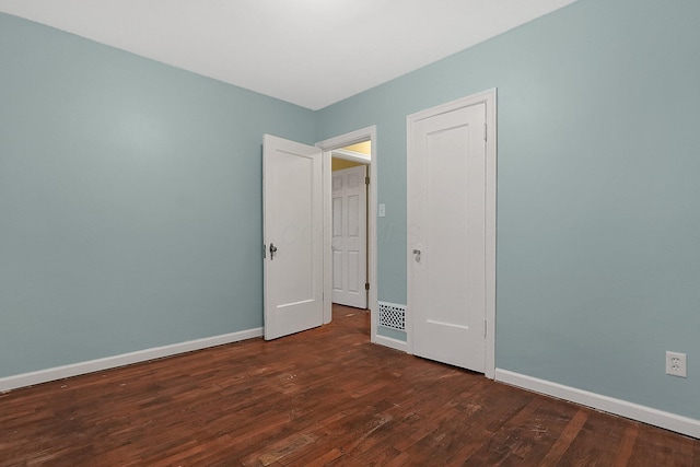 spare room with dark wood-type flooring