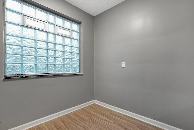 spare room with wood-type flooring and a textured ceiling