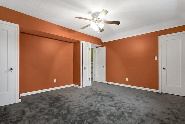 unfurnished bedroom with dark colored carpet and ceiling fan