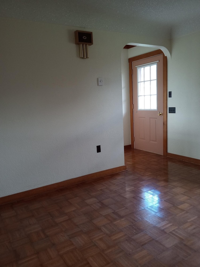 interior space featuring dark parquet flooring