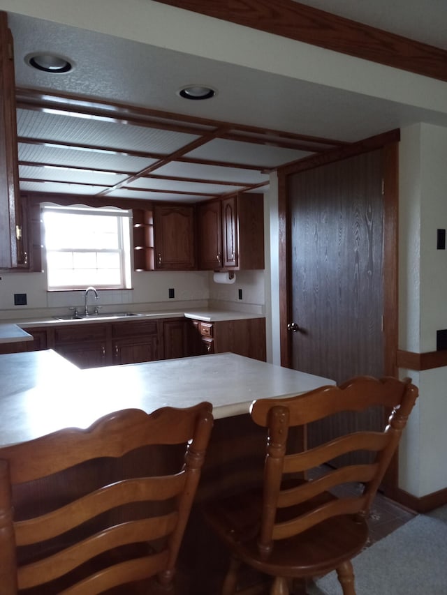 kitchen featuring kitchen peninsula and sink