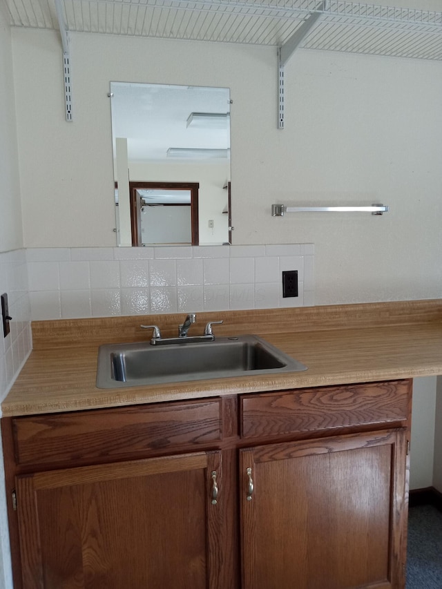 bathroom with vanity and tasteful backsplash