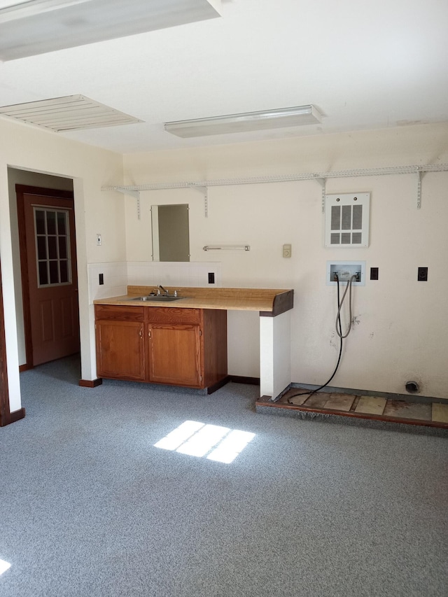 interior space featuring washer hookup, light colored carpet, and sink