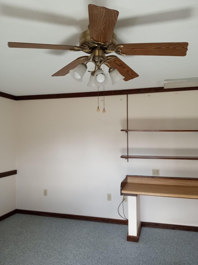 stairway with ceiling fan, carpet floors, and crown molding