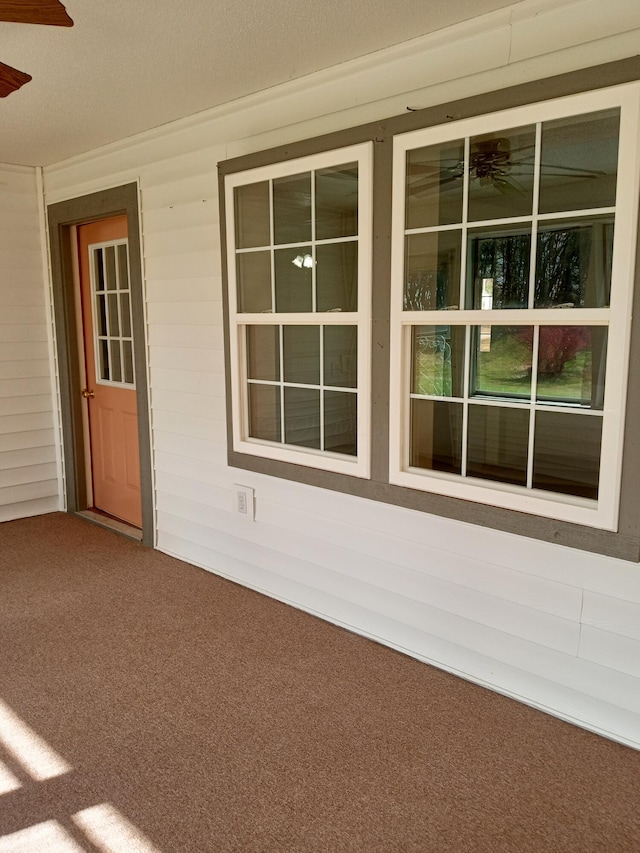 entrance to property with ceiling fan