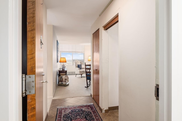 hall with light tile patterned floors