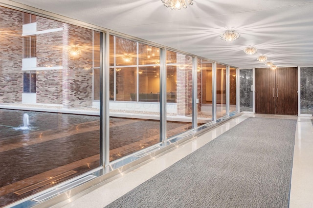 unfurnished sunroom featuring a notable chandelier