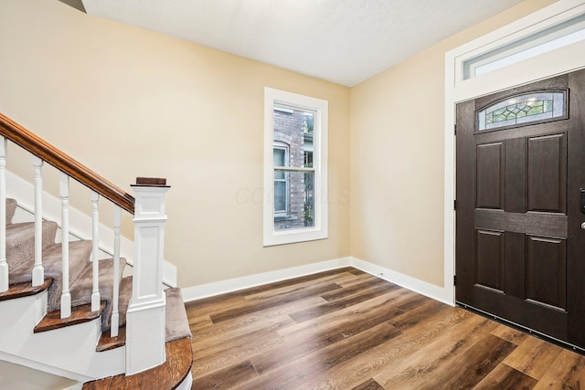 entrance foyer with hardwood / wood-style floors and a textured ceiling