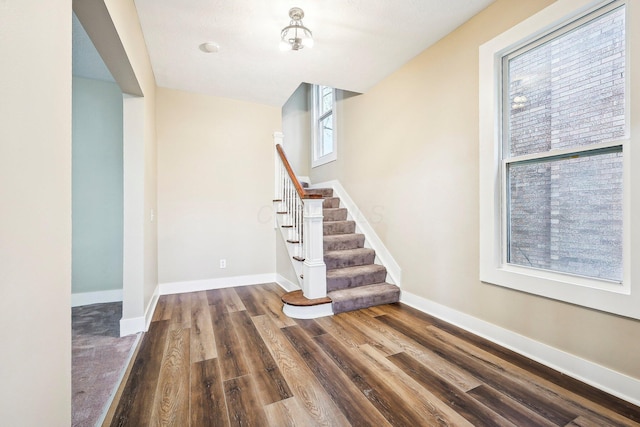 stairs featuring hardwood / wood-style flooring