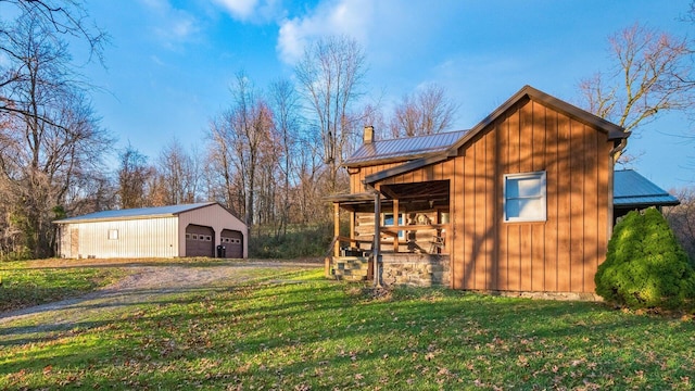 view of outdoor structure featuring a garage and a lawn