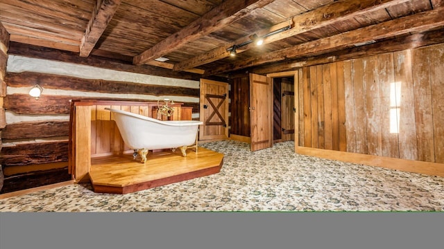 interior space featuring wooden walls, beamed ceiling, and wood ceiling