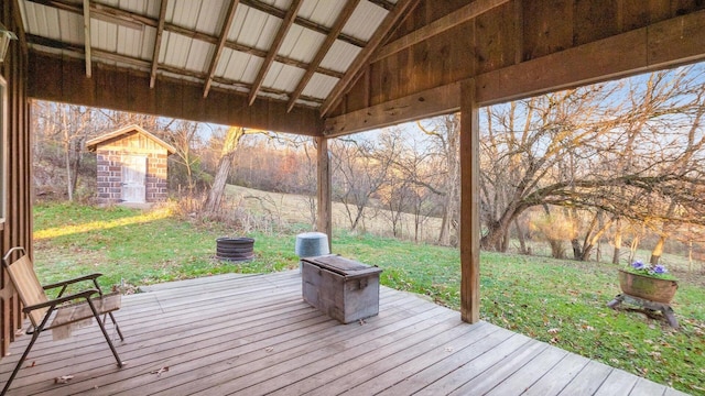 deck with a yard and a storage shed