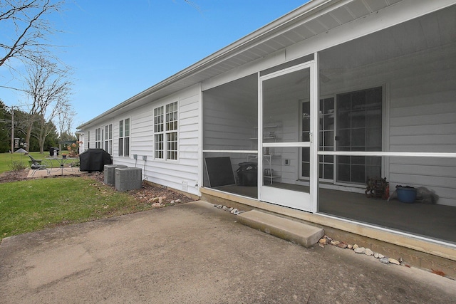 view of home's exterior with a sunroom, a yard, and cooling unit