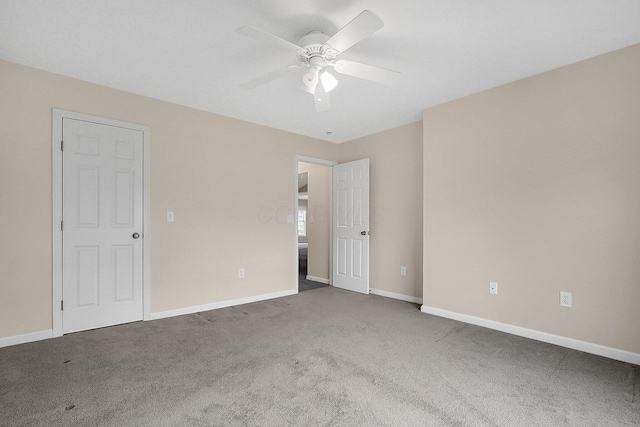 carpeted empty room featuring ceiling fan