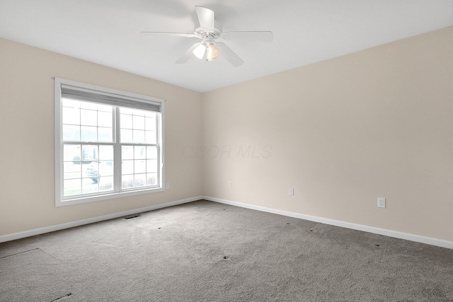 carpeted spare room with ceiling fan