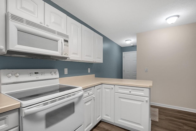 kitchen featuring kitchen peninsula, white cabinets, dark hardwood / wood-style floors, and white appliances