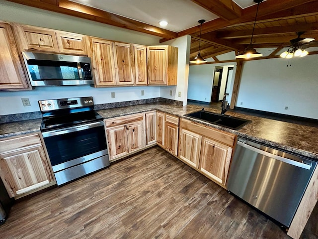 kitchen with dark hardwood / wood-style flooring, stainless steel appliances, ceiling fan, lofted ceiling with beams, and hanging light fixtures