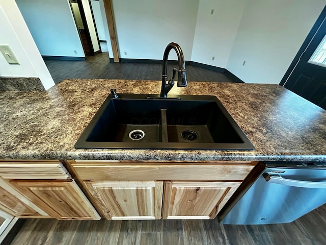 details featuring dishwasher, sink, light brown cabinetry, and dark wood-type flooring