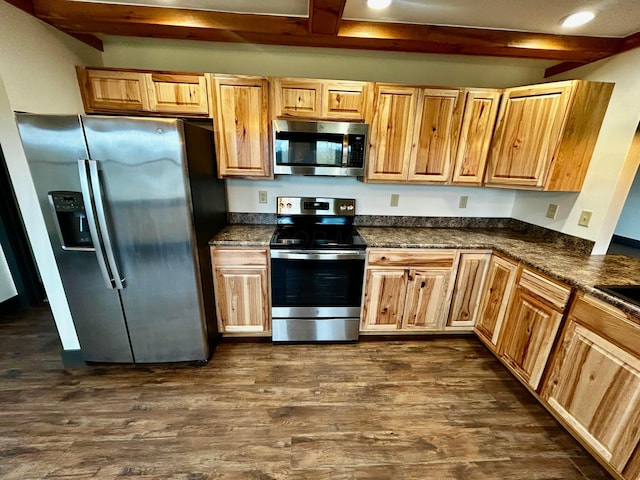 kitchen with appliances with stainless steel finishes, dark wood-type flooring, and beam ceiling