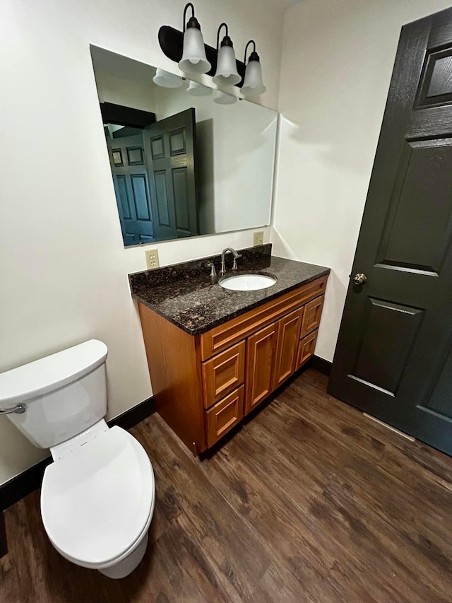 bathroom featuring hardwood / wood-style floors, vanity, and toilet