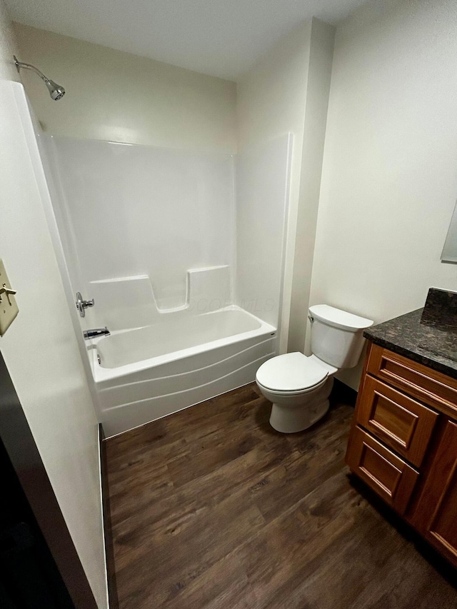 full bathroom with wood-type flooring, vanity, toilet, and tub / shower combination