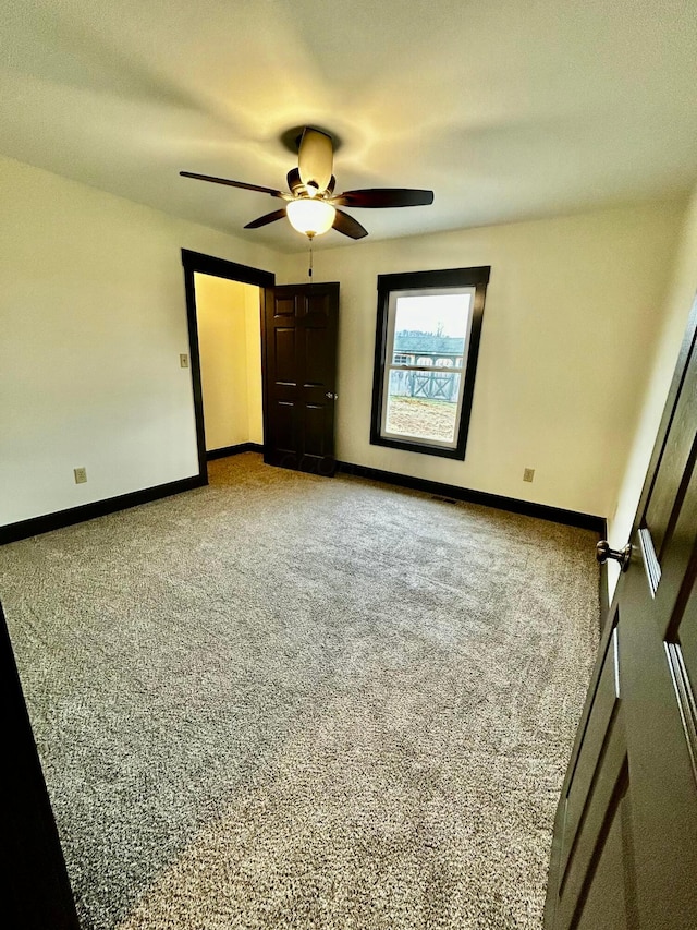 unfurnished bedroom with carpet flooring and ceiling fan