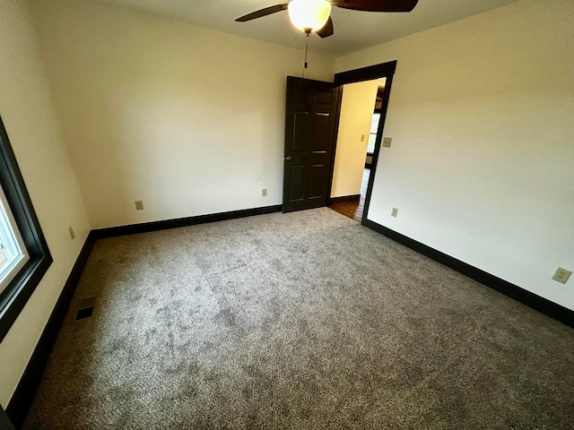 spare room featuring carpet flooring and ceiling fan