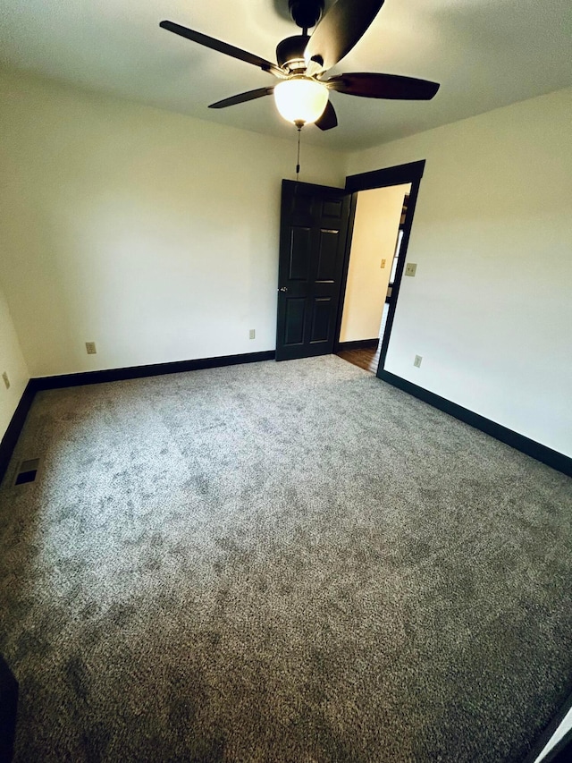 spare room with ceiling fan and carpet floors