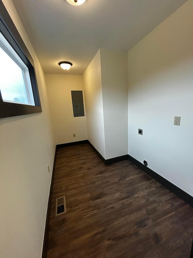 hall with dark hardwood / wood-style floors and electric panel