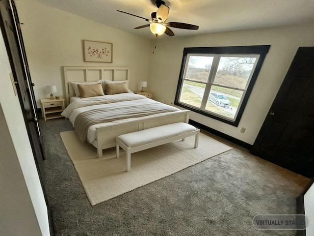 bedroom with vaulted ceiling, dark carpet, and ceiling fan