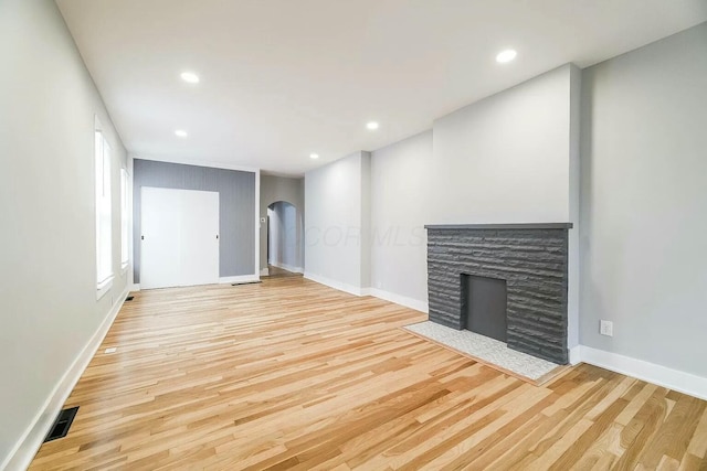 unfurnished living room featuring light hardwood / wood-style floors and a fireplace