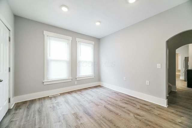 spare room featuring light wood-type flooring