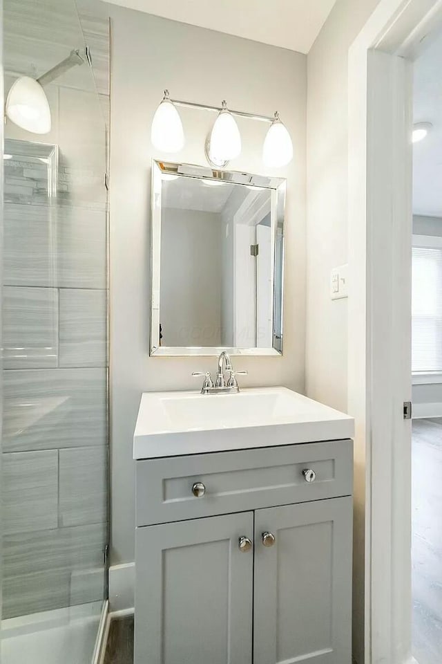 bathroom with vanity and tiled shower