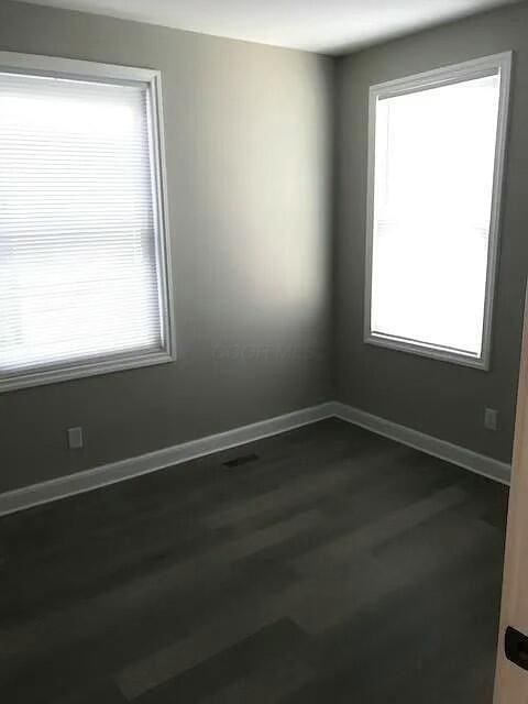 spare room with hardwood / wood-style flooring