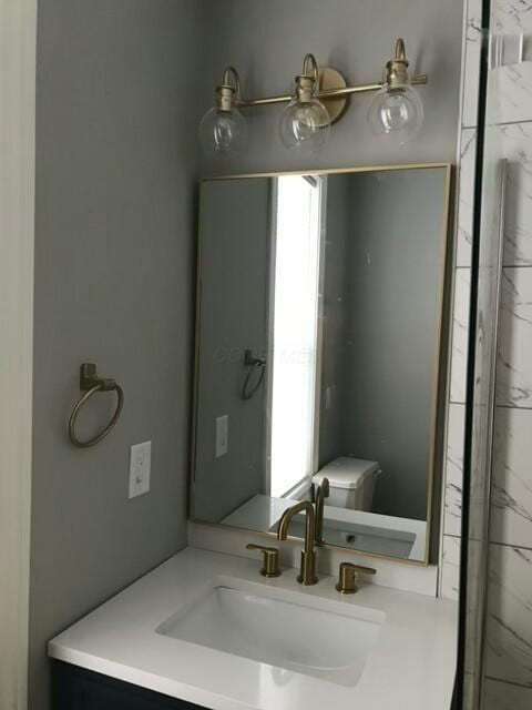 bathroom featuring vanity, toilet, and a wealth of natural light