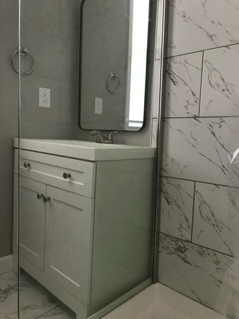 bathroom with vanity and walk in shower