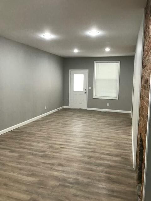 spare room featuring dark hardwood / wood-style flooring