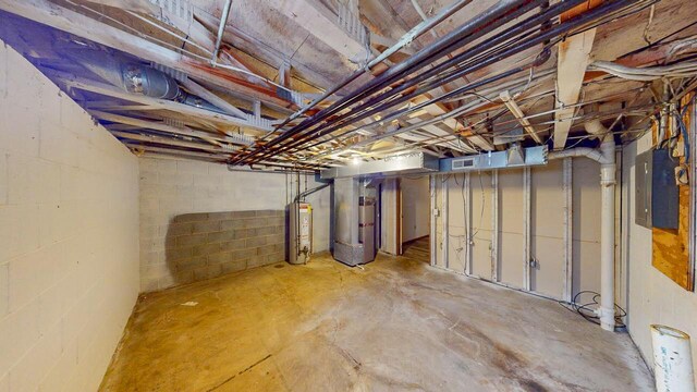 basement featuring heating unit, electric panel, and water heater