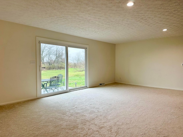 empty room featuring carpet and a textured ceiling