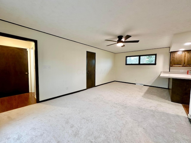 unfurnished bedroom with ceiling fan and light carpet