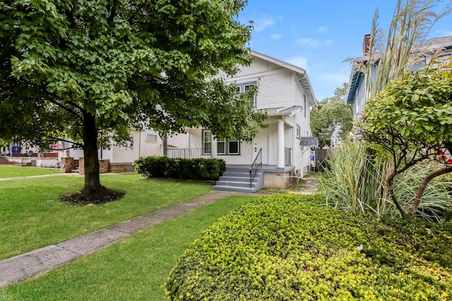 view of front facade with covered porch and a front yard