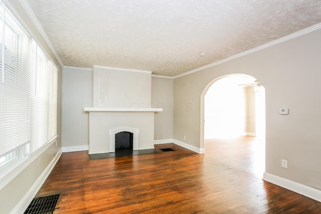 unfurnished living room featuring a textured ceiling, dark hardwood / wood-style flooring, and crown molding