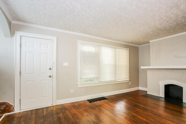 811 S Richardson Ave, Columbus, OH 43204 - unfurnished living room featuring wood finished floors, a fireplace with flush hearth, a textured ceiling, and crown molding