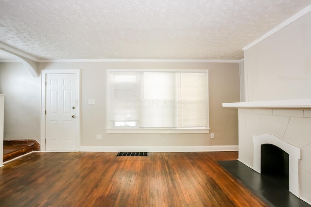 811 S Richardson Ave, Columbus, OH 43204 - unfurnished living room with hardwood / wood-style floors, a textured ceiling, ornamental molding, and arched walkways