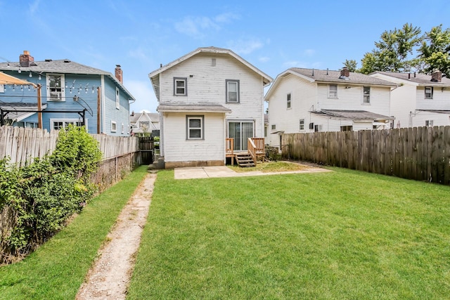 rear view of property featuring a yard